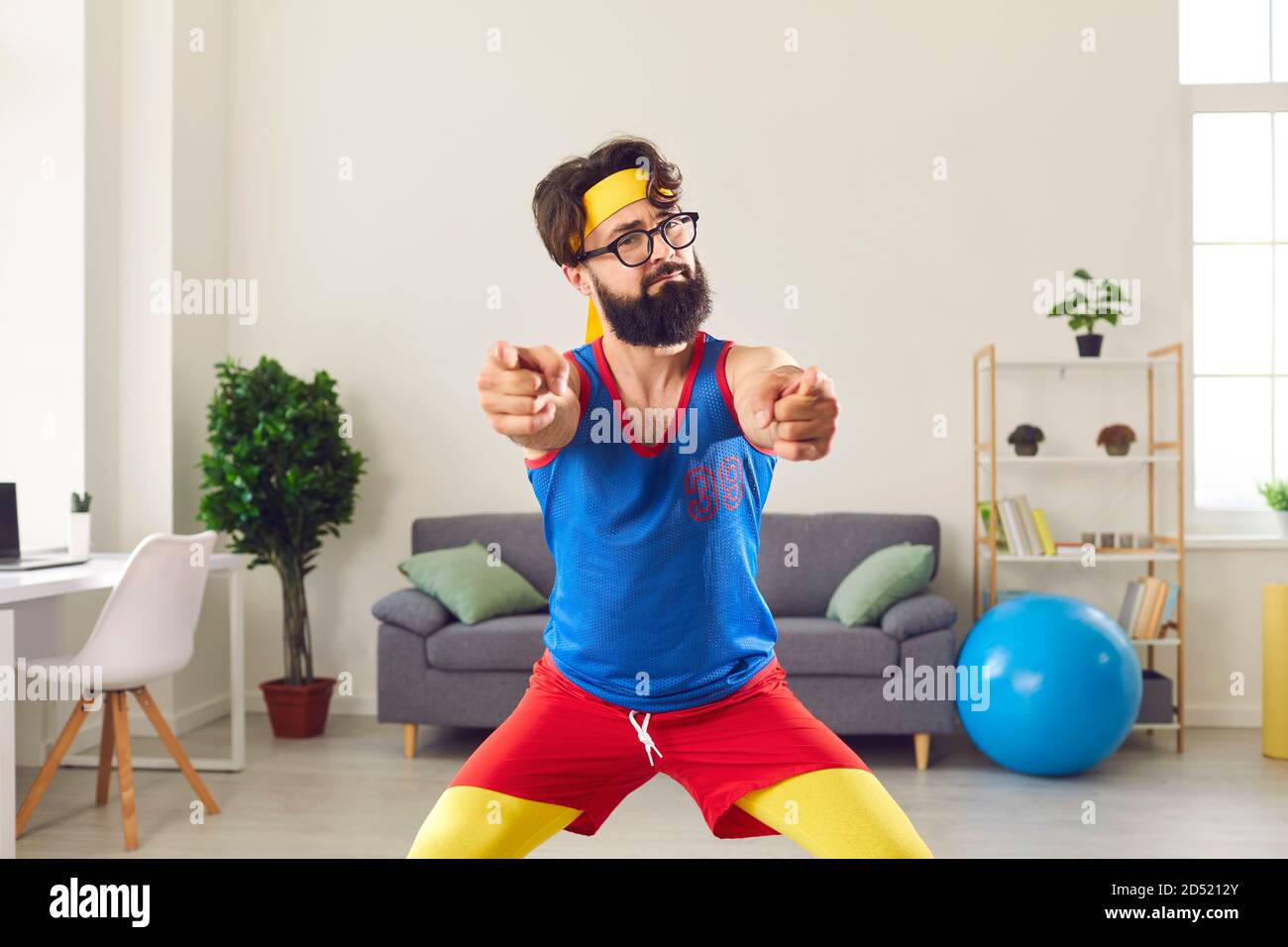 Funny fitness trainer in retro sportswear pointing at camera motivating you  to start training Stock Photo - Alamy
