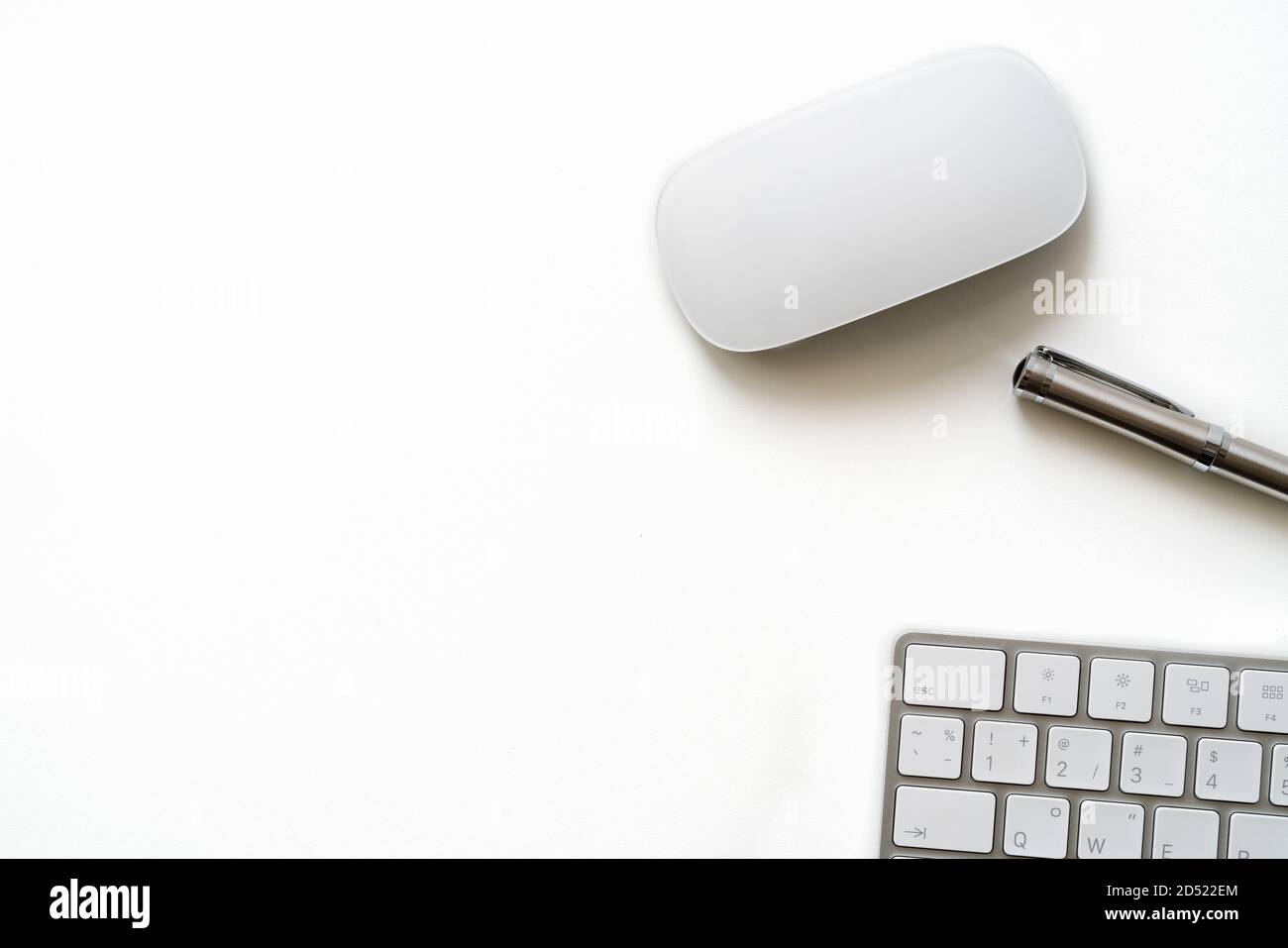 White Table with luxury pen, computer keyboard and mouse Stock Photo