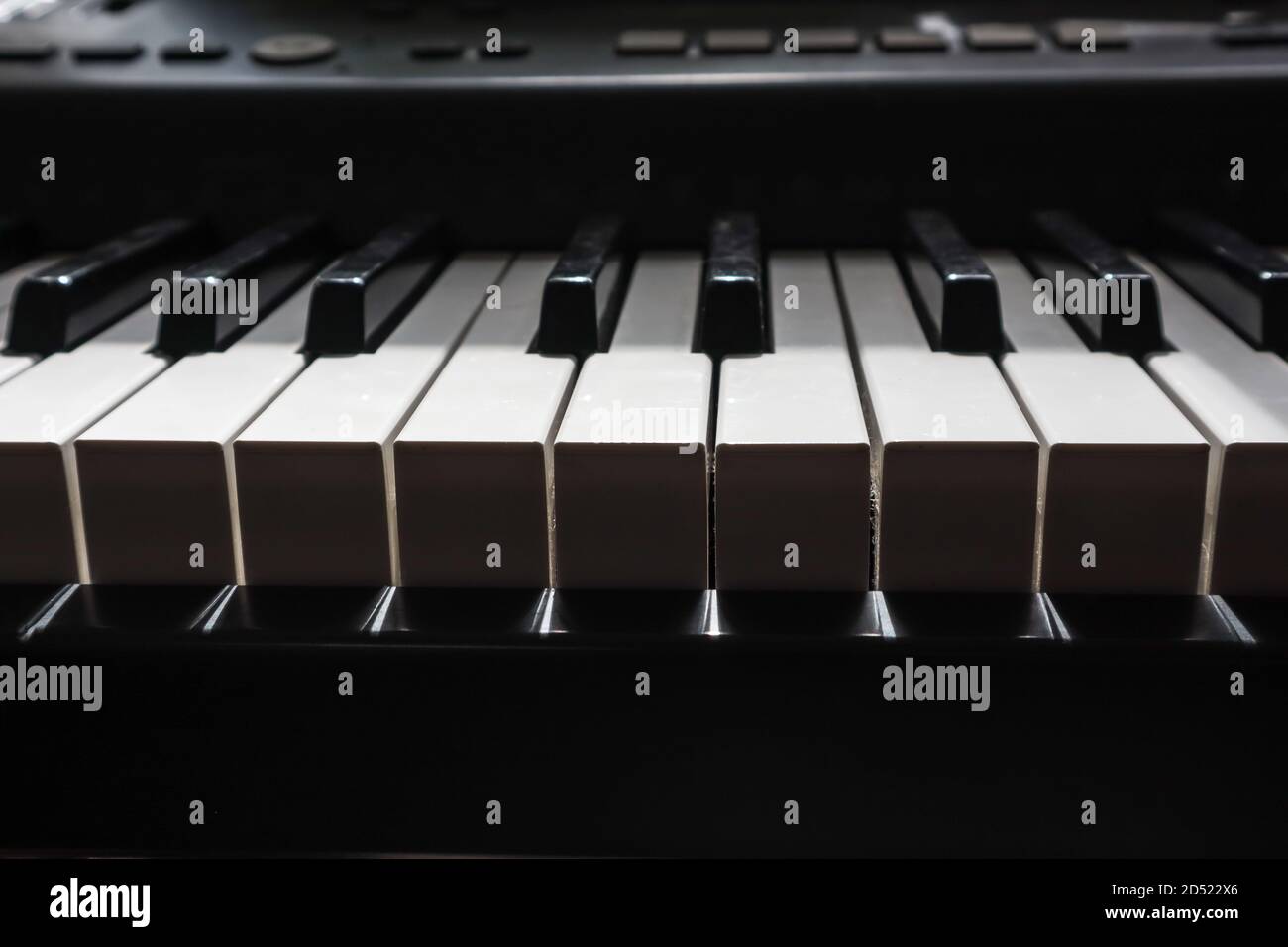 piano keys in bright light and dark shadow Stock Photo