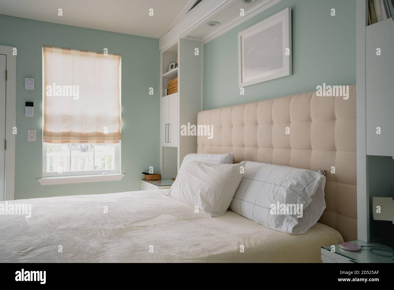 clean bedroom interior with beige and green color scheme Stock Photo