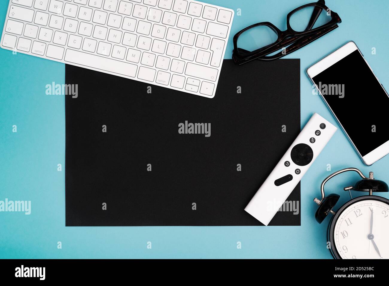 black paper copyspace with computer keyboard, glasses, smartphone and clock. topview, copy space Stock Photo
