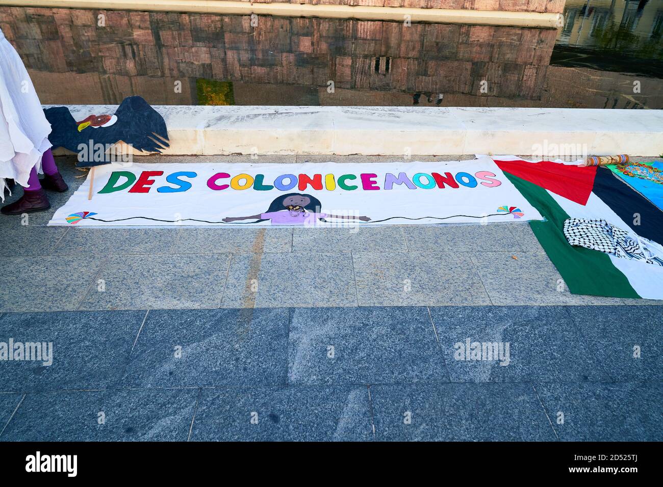 Let's decolonize reads a colourful banner, Plaza Colon, Dia Nacional de España, Dia de la Hispanidad, protest, Madrid, Spain, October 12th 2020 Stock Photo