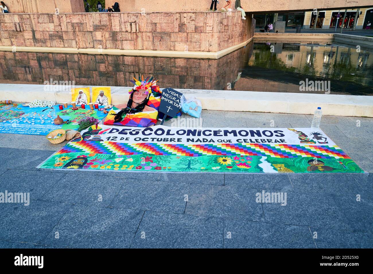 Let's decolonize reads a colourful banner, Plaza Colon, Dia Nacional de España, Dia de la Hispanidad, protest, Madrid, Spain, October 12th 2020 Stock Photo