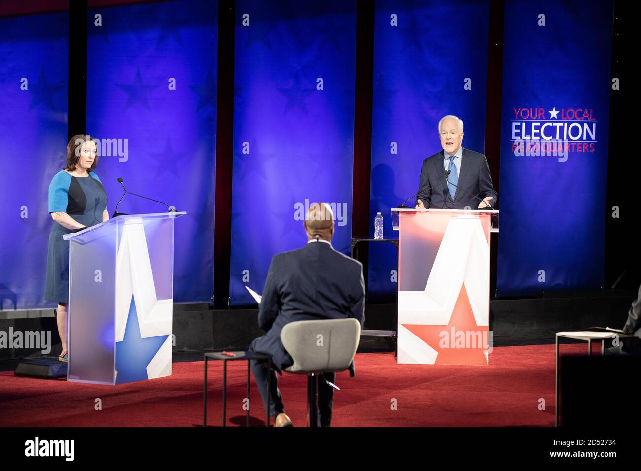 Austin TX USA, Oct. 9 2020: Democratic challenger MJ Hegar (l) answers a question while debating three-term U.S. Senator John Cornyn. The 44-year old decorated war veteran attempts to unseat Cornyn, a Republican stalwart. Moderator Gromer Jeffers Jr. sits in the foreground. Stock Photo
