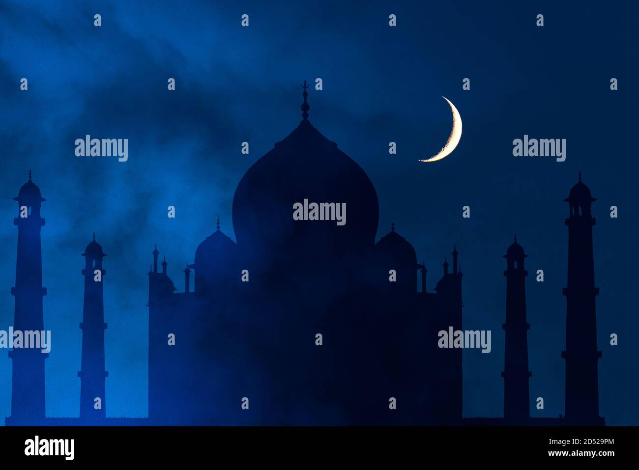 Mysterious foggy night with crescent moon over Taj Mahal in India, Agra Stock Photo