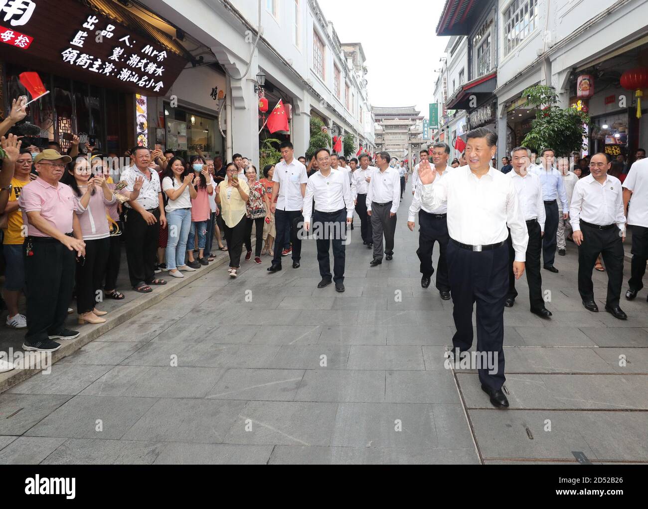 Chaozhou, China's Guangdong Province. 12th Oct, 2020. Chinese President Xi Jinping, also general secretary of the Communist Party of China Central Committee and chairman of the Central Military Commission, waves to people while visiting a street lined with ancient memorial archways in Chaozhou, south China's Guangdong Province, Oct. 12, 2020. Xi on Monday arrived in Guangdong to begin an inspection tour of the province. Credit: Wang Ye/Xinhua/Alamy Live News Stock Photo
