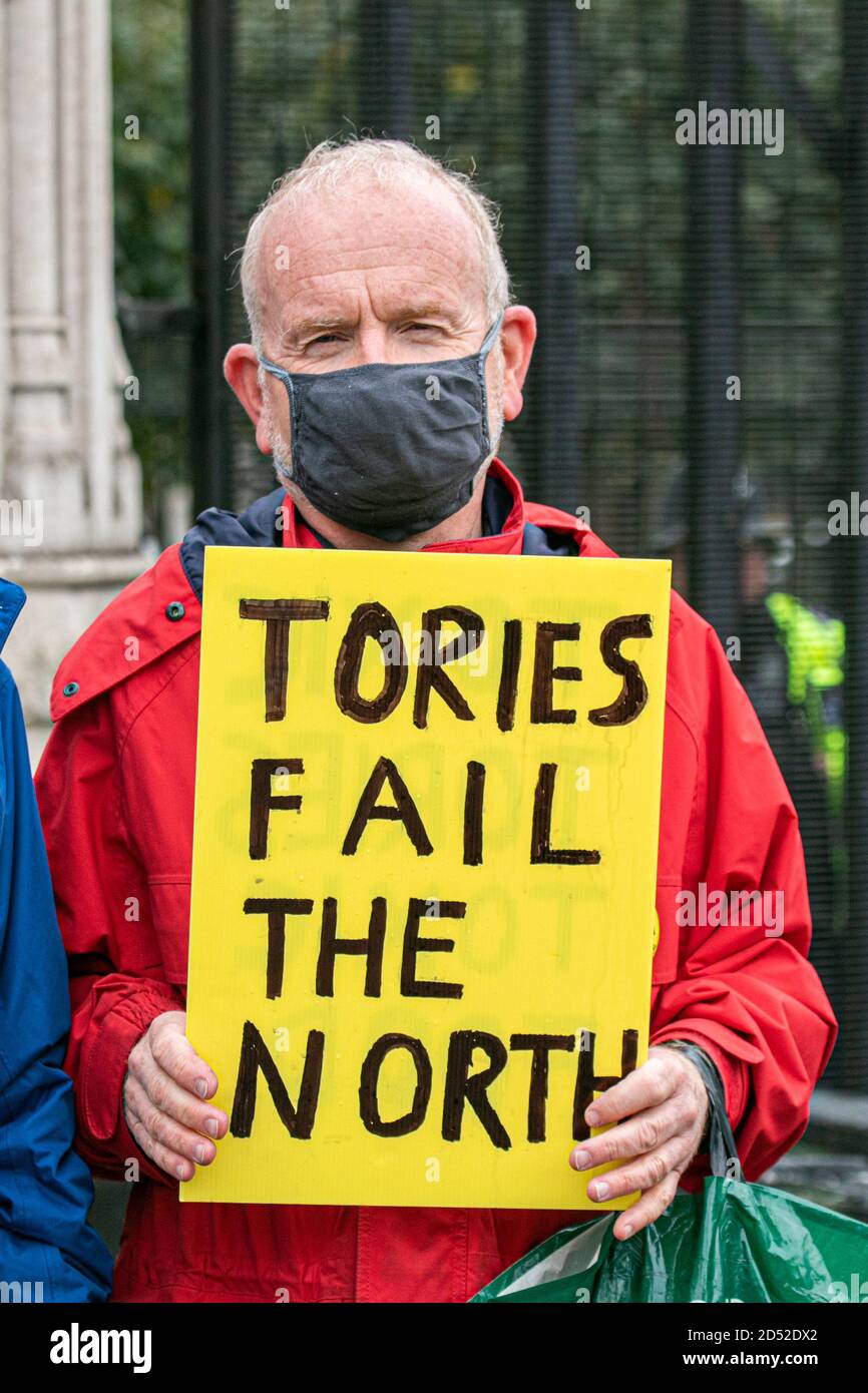 WESTMINSTER LONDON,UK  12 October 2020. A protester outside Parliament holds a sign ' Tories fail the north. The UK has reported an exponential rise with more than 12,000 new covid-19 cases that has resulted in local lockdowns across the north of England. The prime minister is introducing a new three-tier system of localised restrictions to contain the spread of covid-19 infections in those locations. Credit: amer ghazzal/Alamy Live News Stock Photo