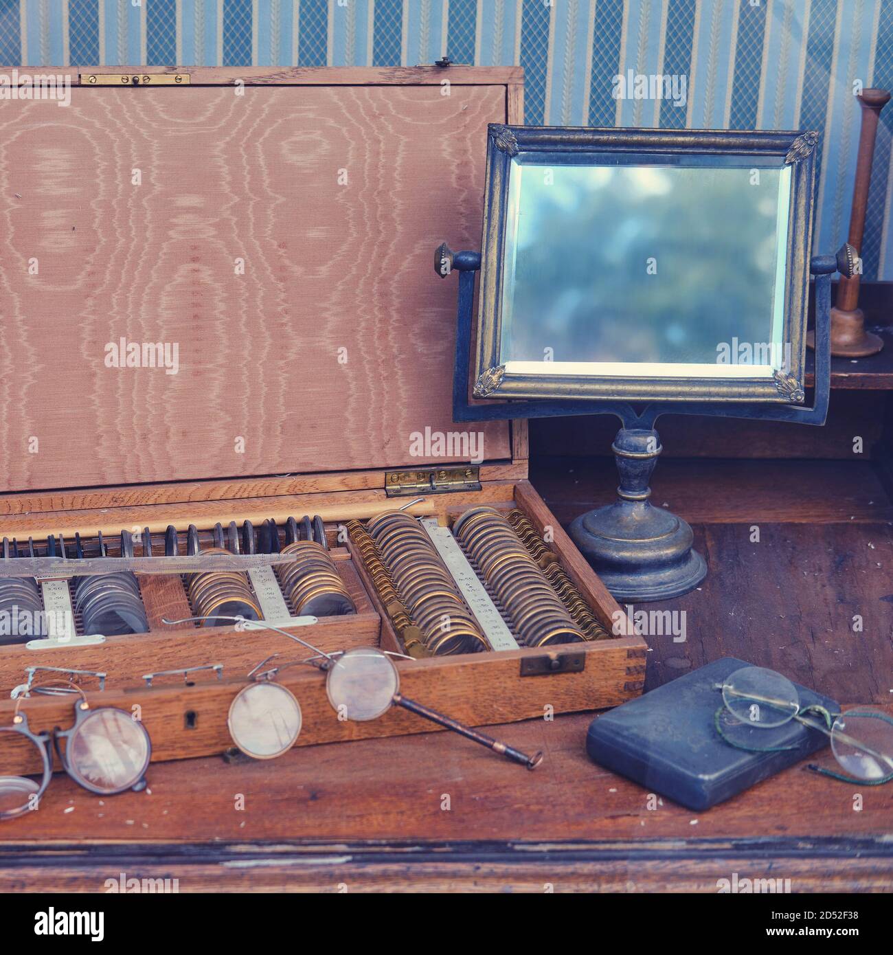 Medical instruments of an old optometrist with a mirror and glasses