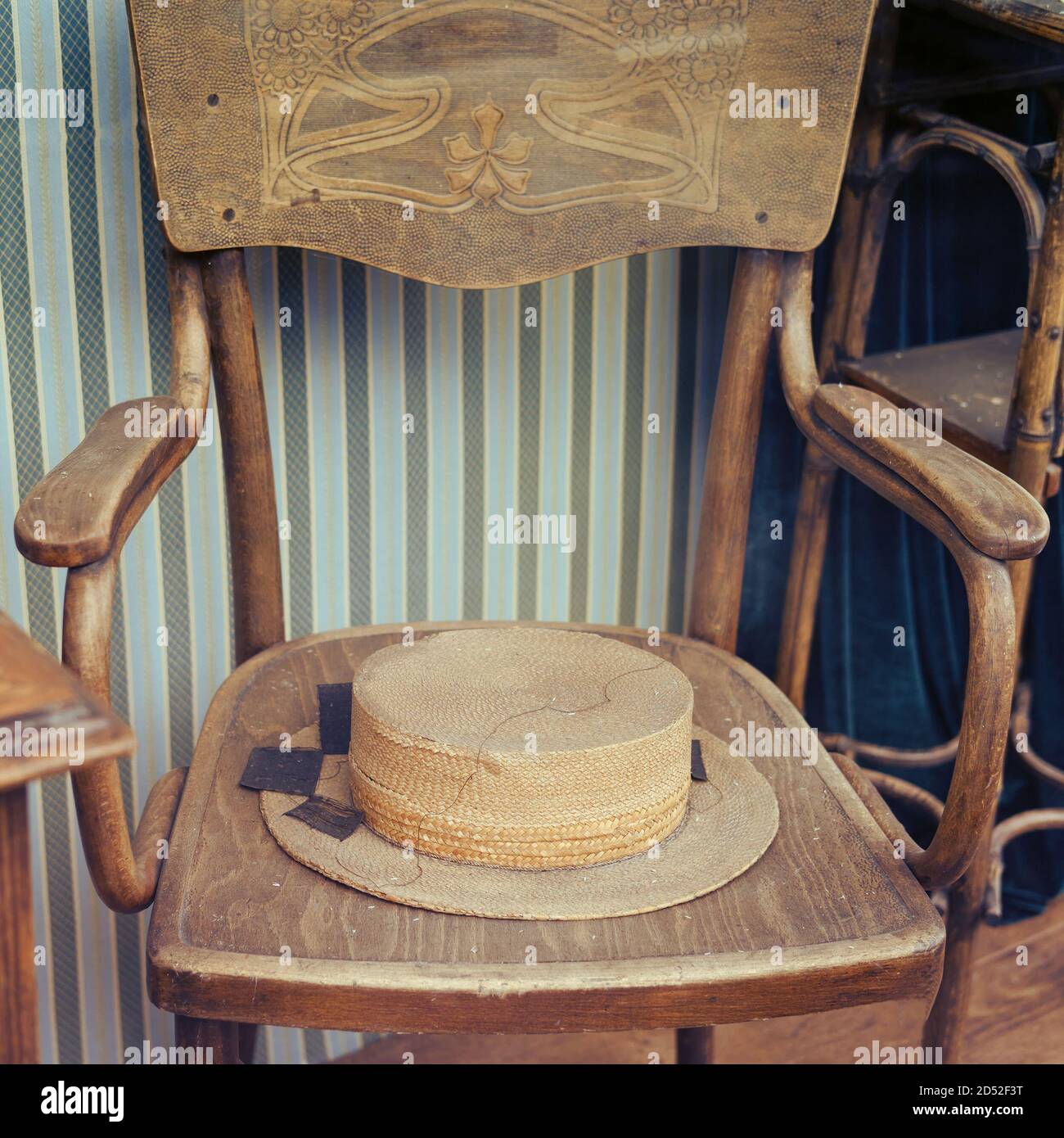 An old straw hat is lying on a vintage chair, close-up Stock Photo - Alamy