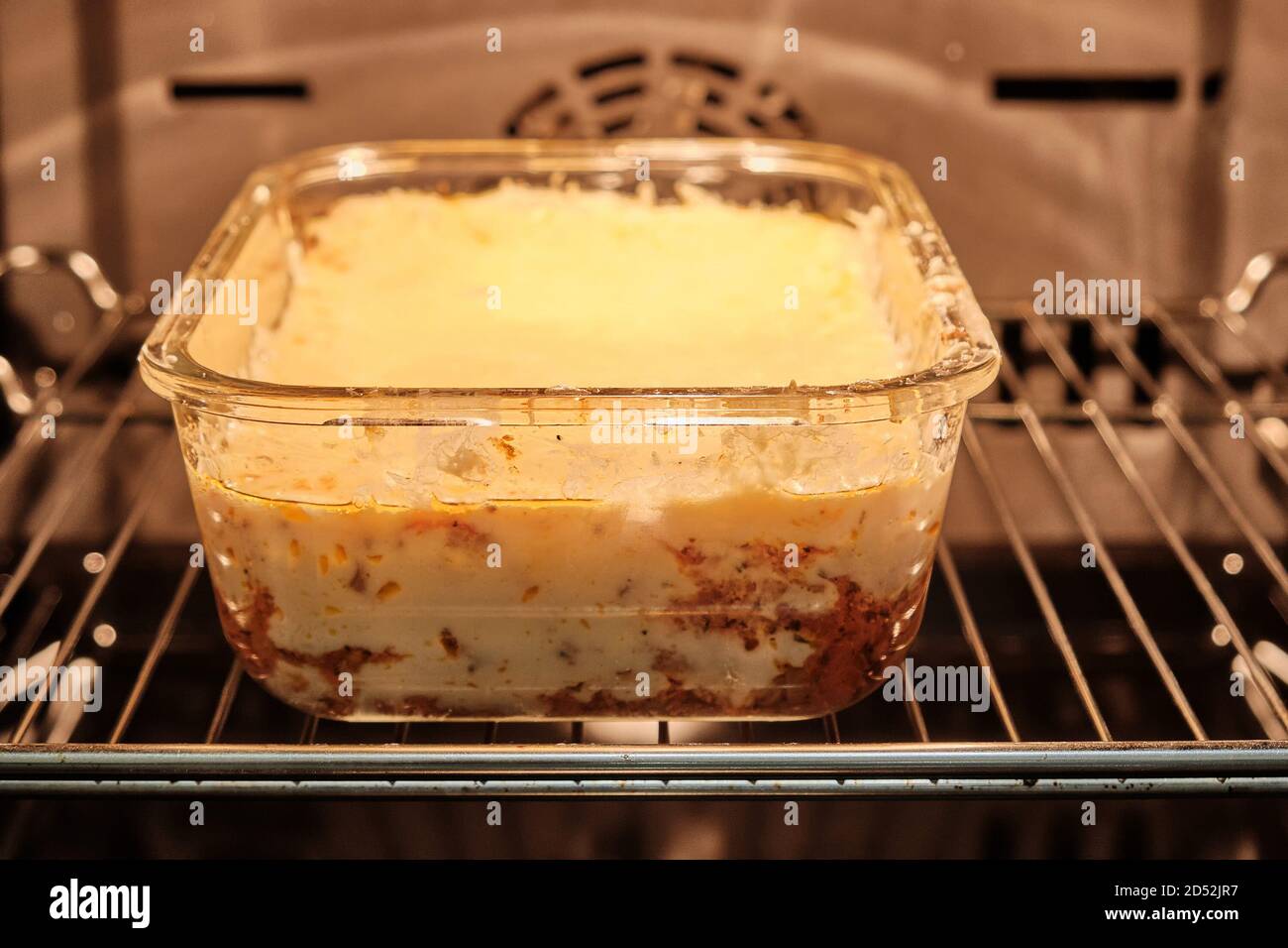 Process of baking cheese lasagna. Cooking Italian dinner in a glass