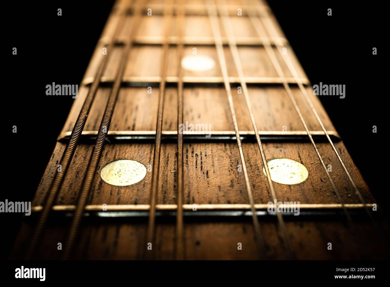 Macro photo of mandolin fretboard at the 12th fret with silver inlays Stock Photo
