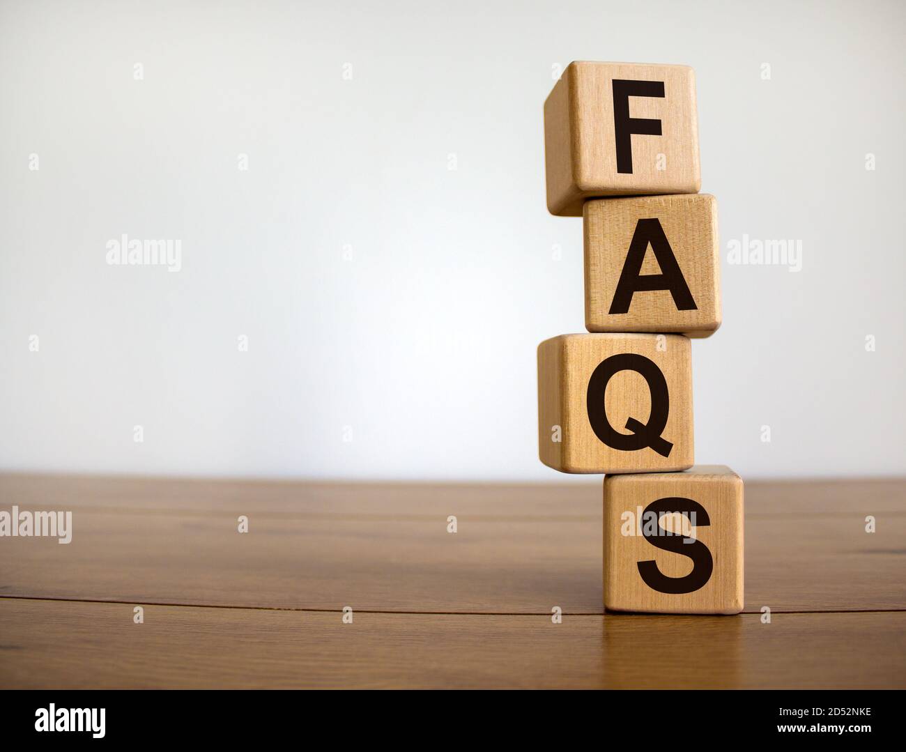 Concept word 'FAQ' on cubes on a beautiful wooden table, white ...