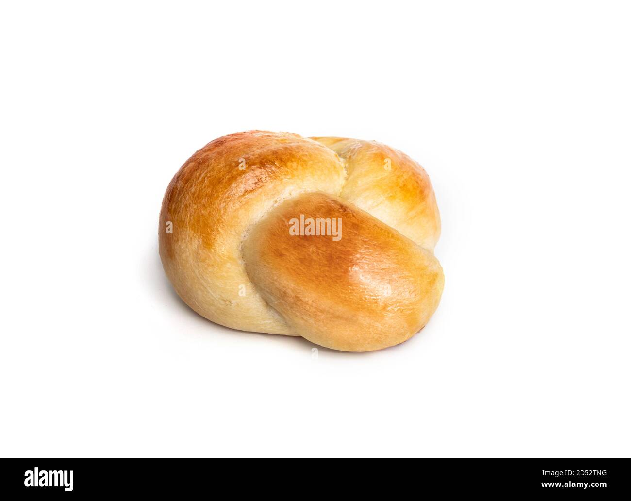 Single yeast bread bun in perspective view. One baked braided yeast knot roll with egg wash. Traditional Swiss butter bread called Zopf or Challah. Stock Photo