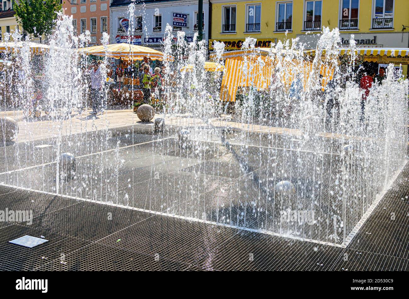 trick fountains on the main place of the city of Tulln in sunshine, Austria Stock Photo