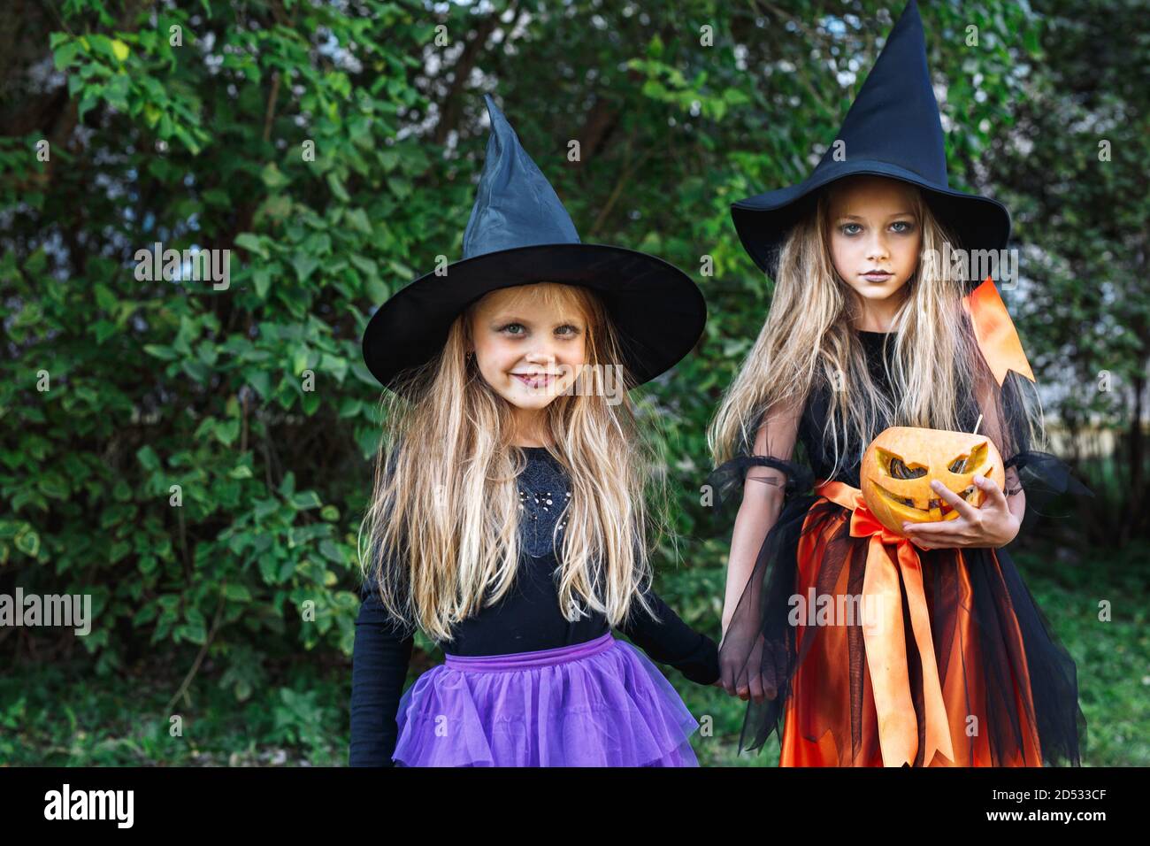 Halloween little girls in witch costume out for trick-or-treating Stock ...