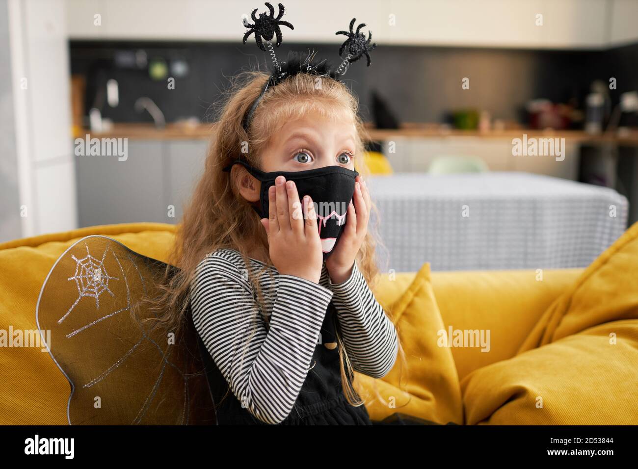 Funny child girl dressed in witch canival costume. Halloween holiday