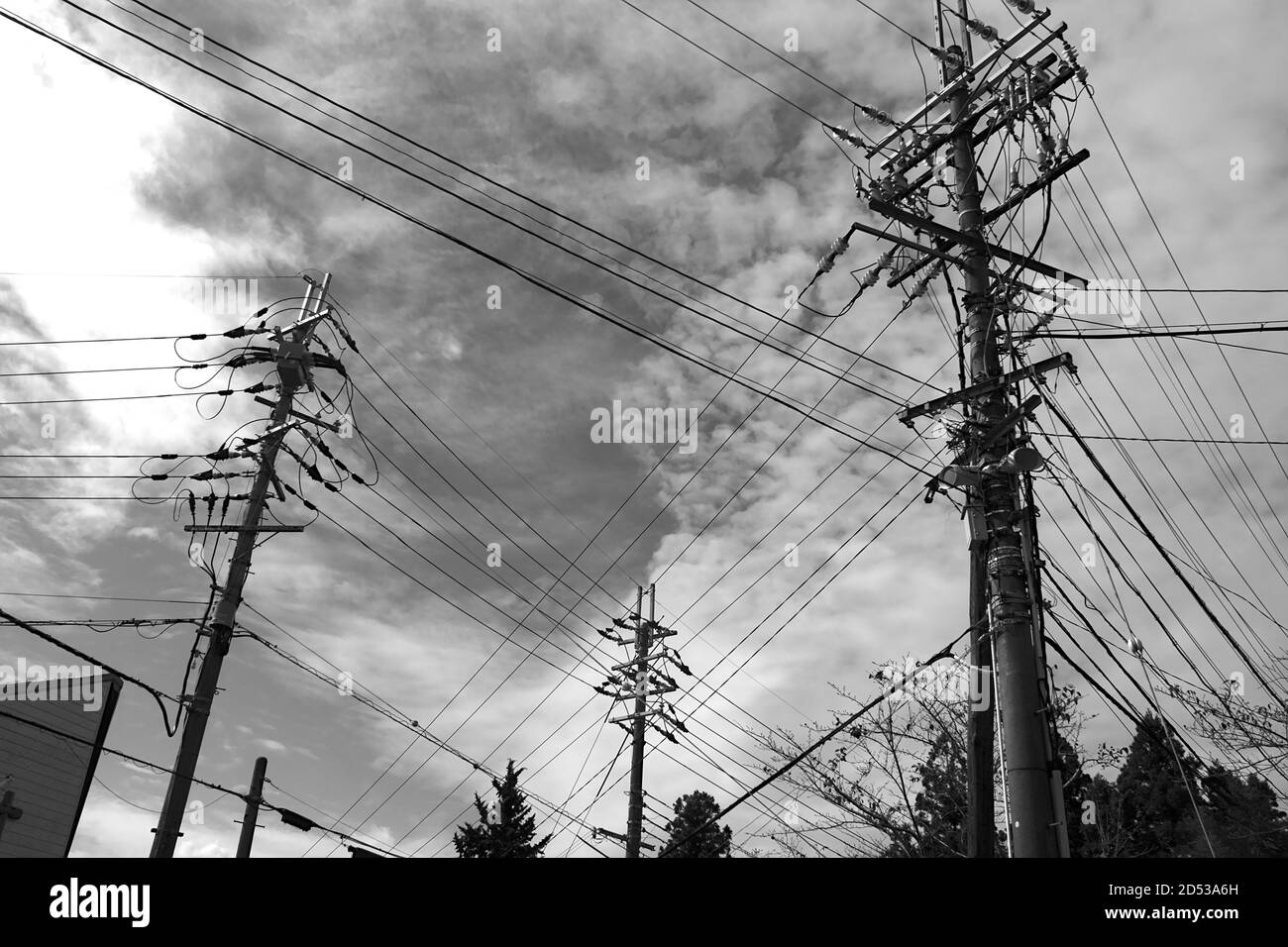 Three High Electricity Poles Loaded with Many Cables in Japan Stock Photo