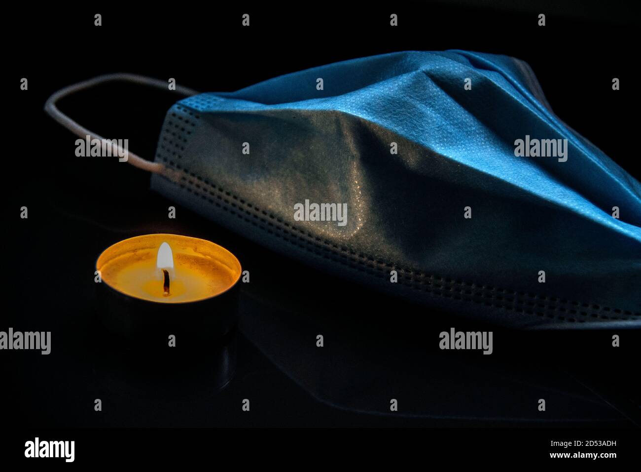 Burning candle and medical face mask Stock Photo Alamy