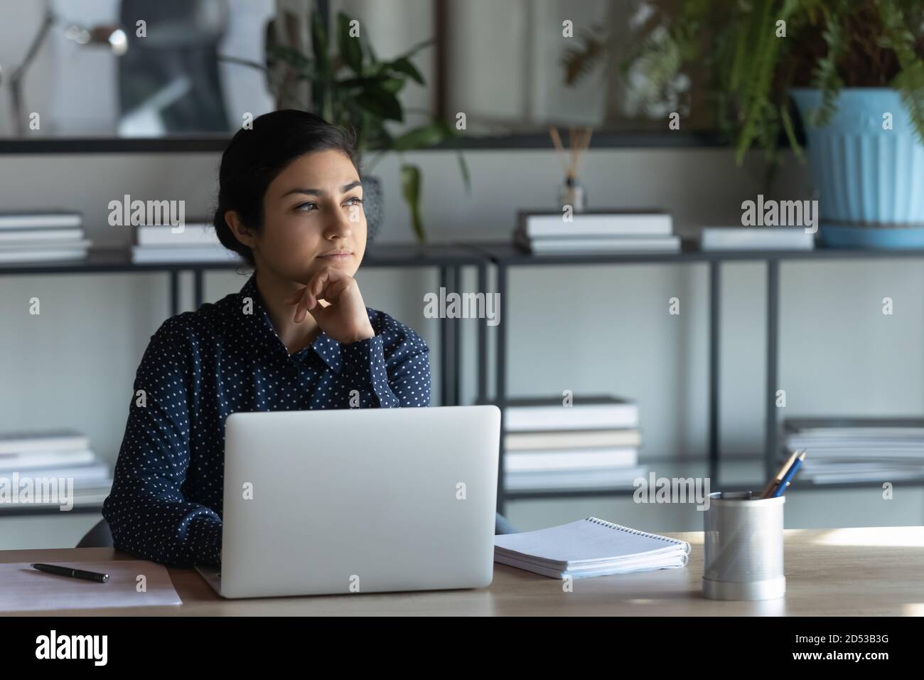 Pensive indian employee work on laptop thinking Stock Photo - Alamy