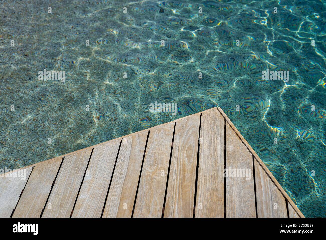 Top view of wood platform or terrace jetty beside the blue crystal clear water background Stock