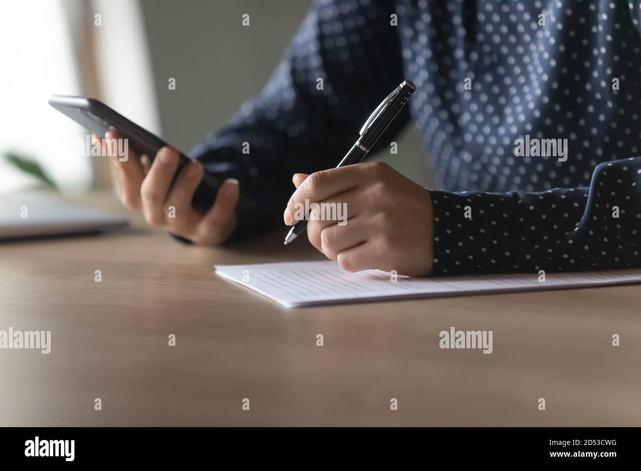 Close up of woman make notes using modern smartphone Stock Photo