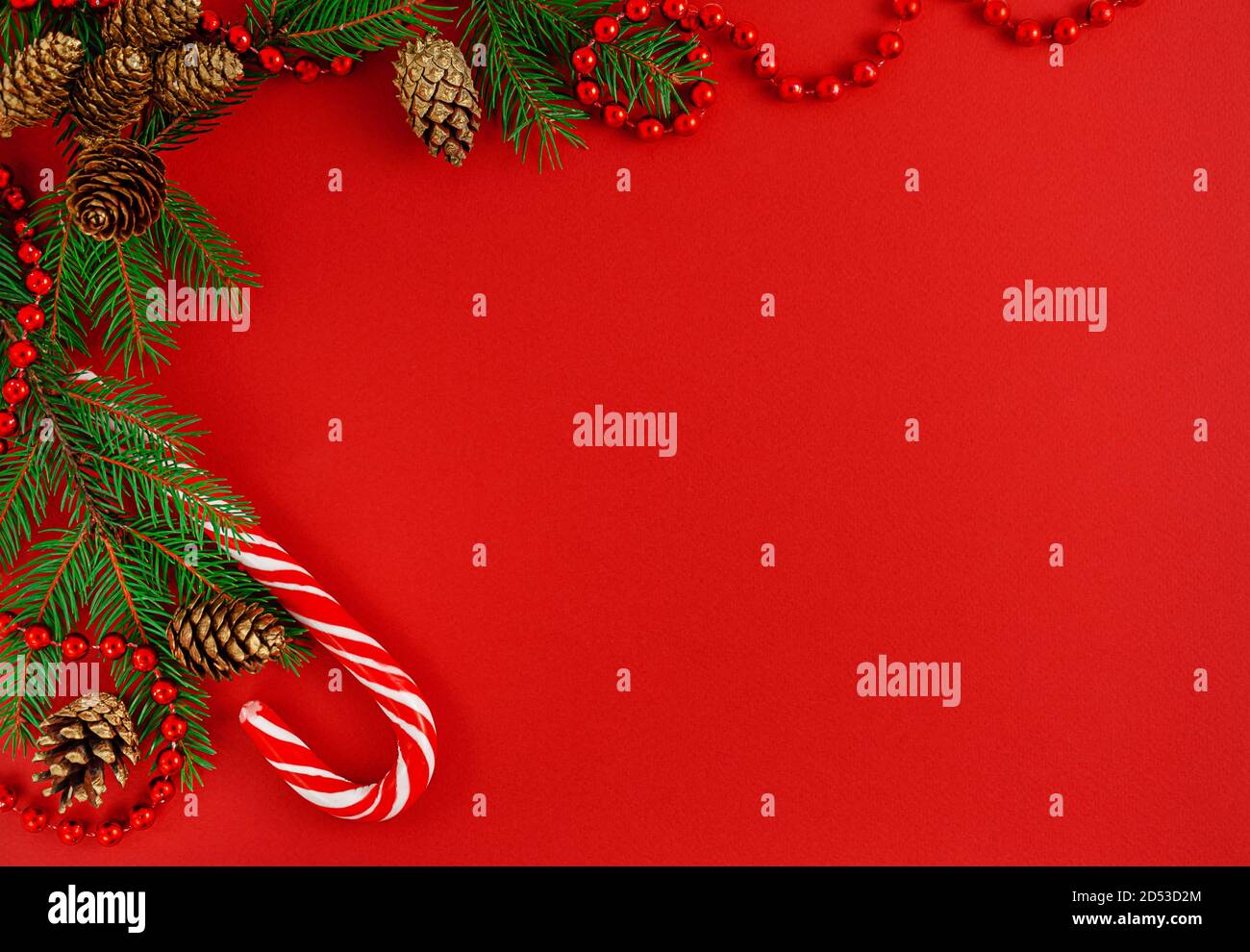 Christmas border composition with candy cane on red background Top Christmas border composition with candy cane on red background Top