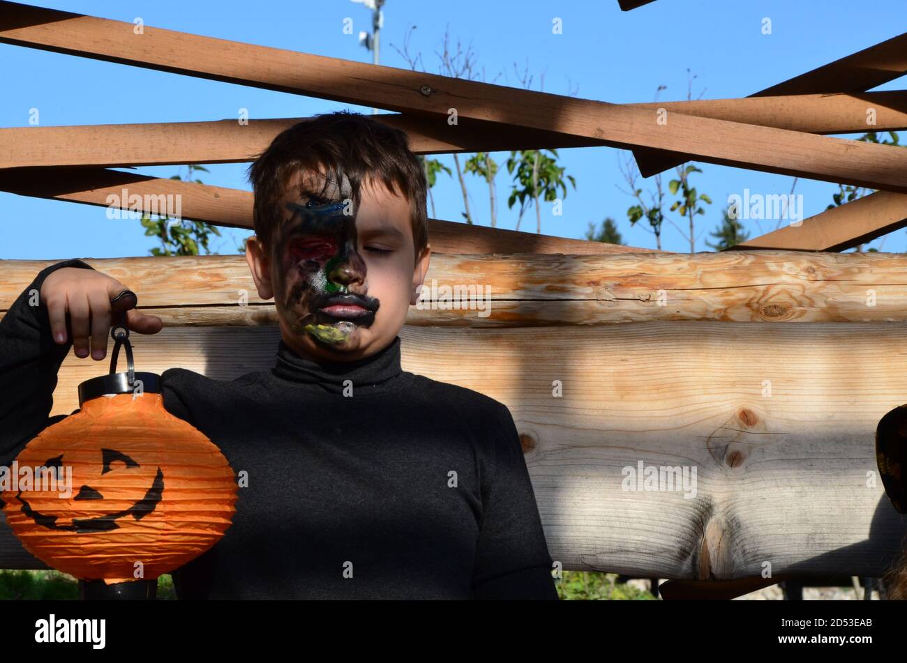 boy with black makeup for halloween, zombie. Scary little boy smiling