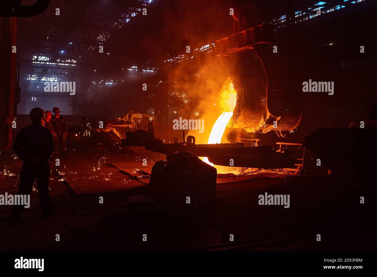Metal casting process in metallurgical plant. Liquid metal pouring into ...