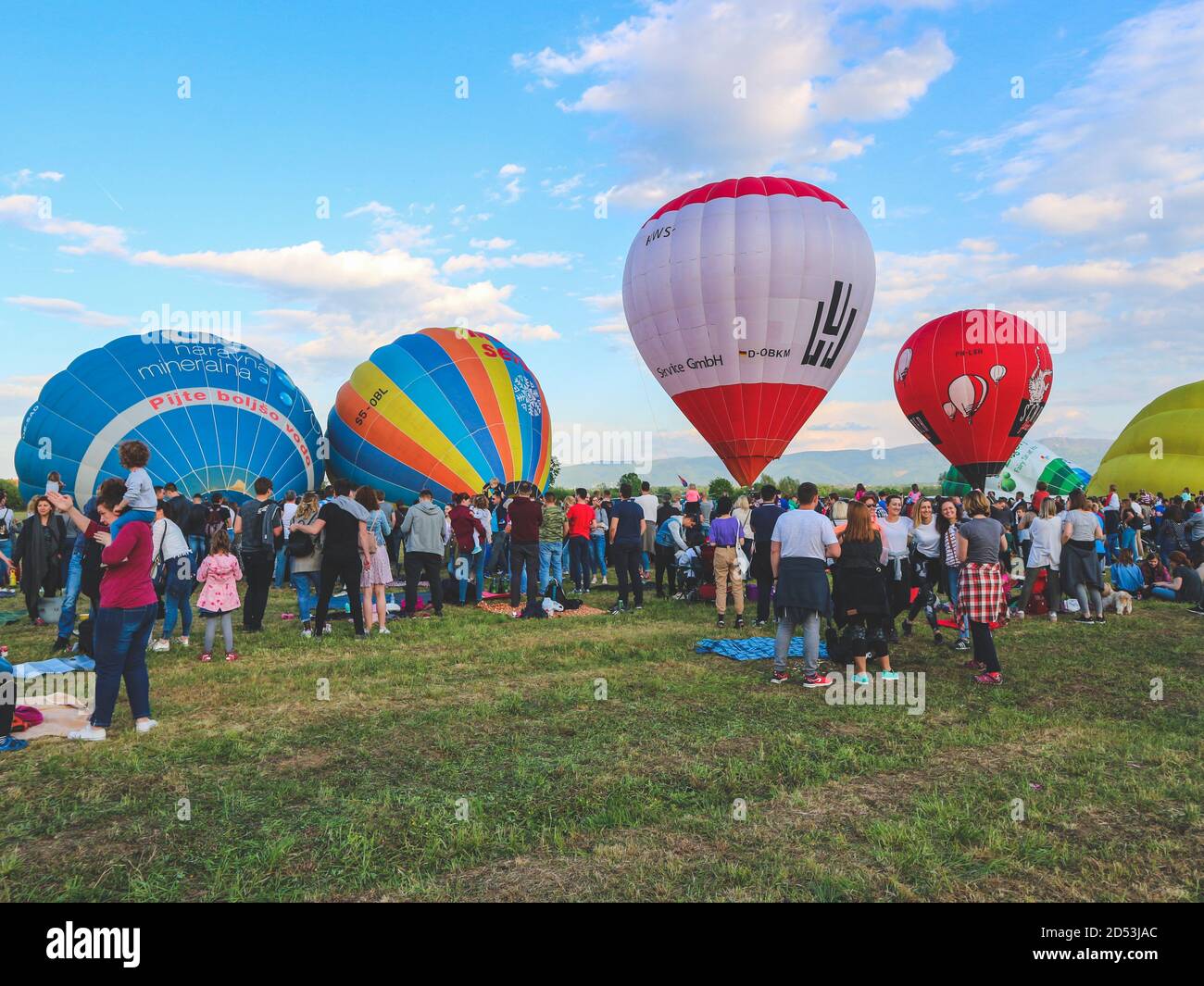 Zapresic/ Croatia-May 1st,2018: People attending hot air baloon festival, with numerous teams flying over the site, observed by the crowd Stock Photo