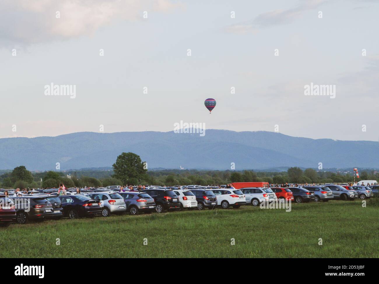 Zapresic/ Croatia-May 1st,2018: People attending hot air baloon festival, with numerous teams flying over the site, observed by the crowd Stock Photo