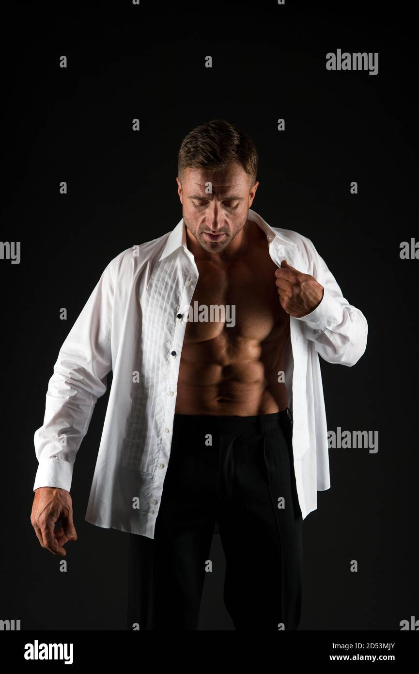 Elegant man show six pack abs torso in open shirt formalwear black  background, businessman Stock Photo - Alamy