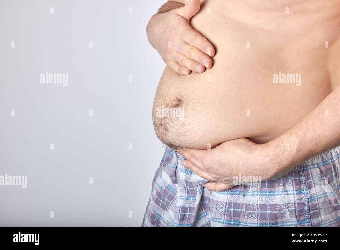 a fat man in shorts with the extra weight Stock Photo