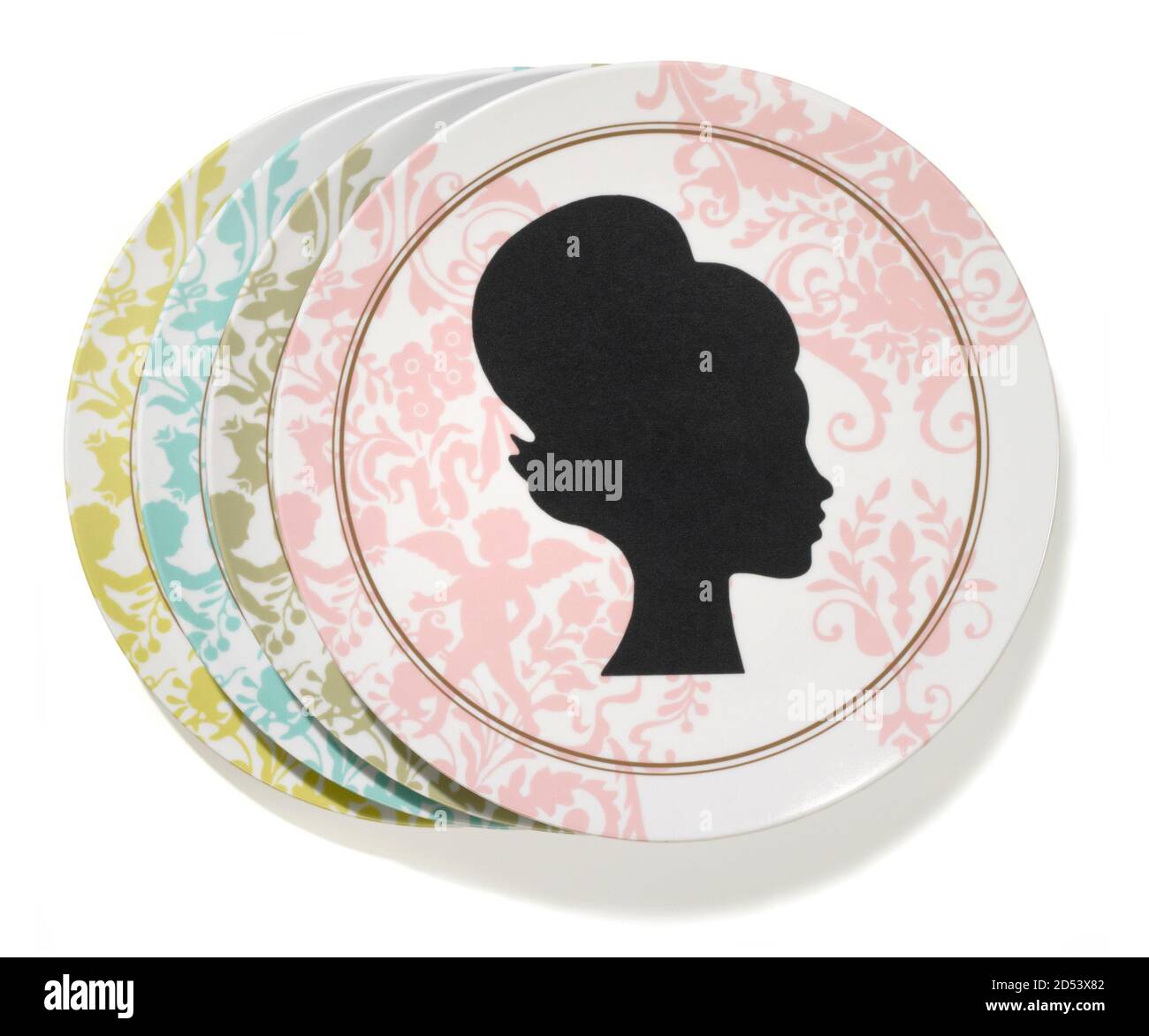Multi-colored dinner plate set with silhouette of a woman's head photographed on a white background Stock Photo