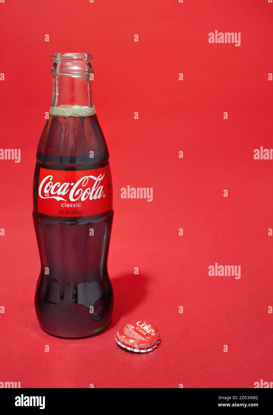 Open glass coca-cola bottle photographed on a red background Stock Photo -  Alamy
