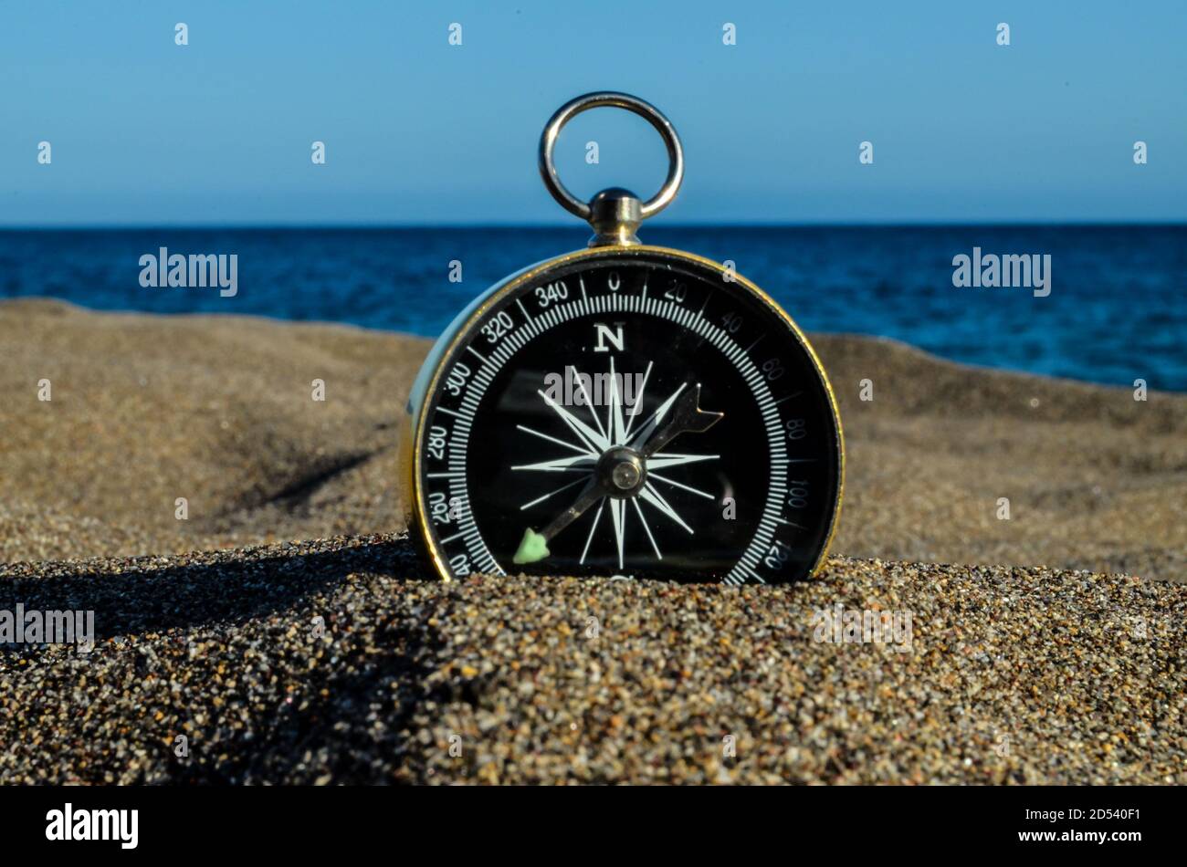 Compass on the Sand Beach Stock Photo - Alamy