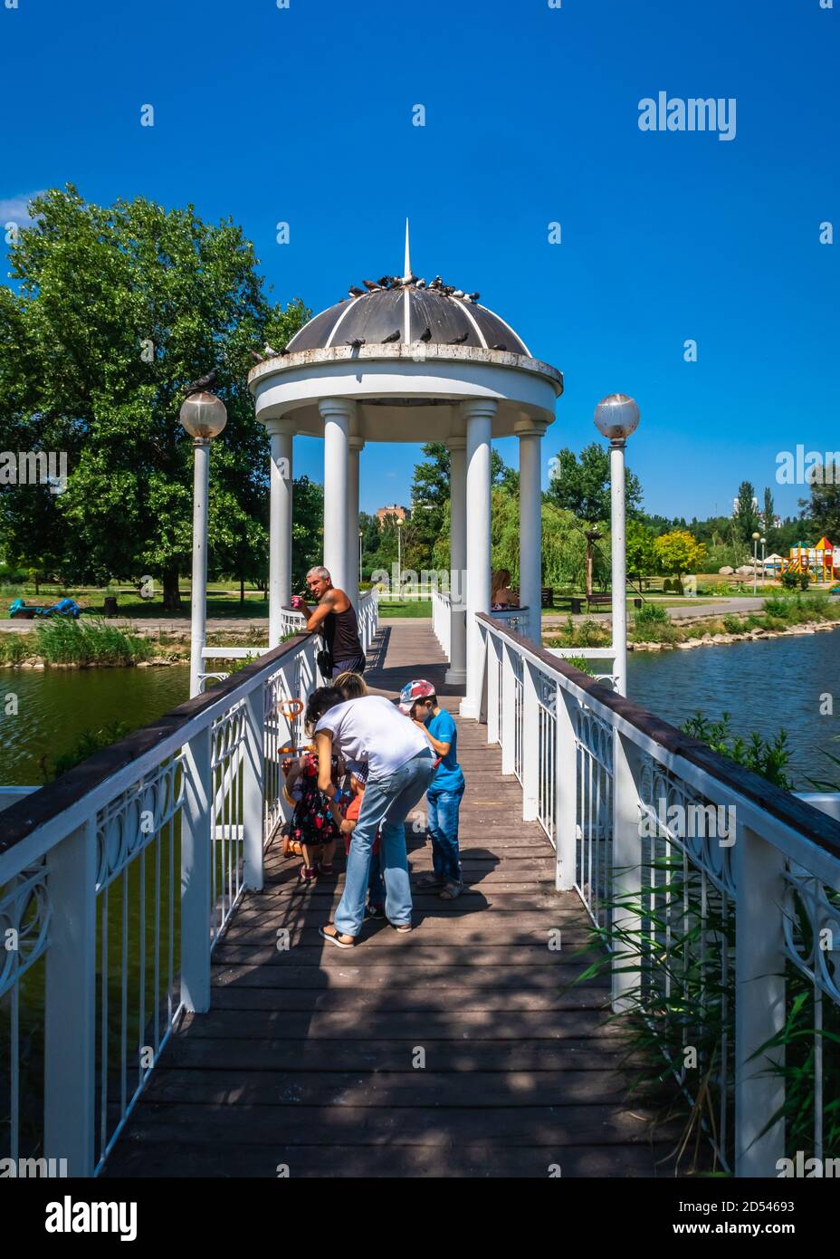 Zaporozhye, Ukraine 07.21.2020. Bridge over the pond and gazebo in Voznesenovsky park in Zaporozhye, Ukraine, on a sunny summer morning Stock Photo