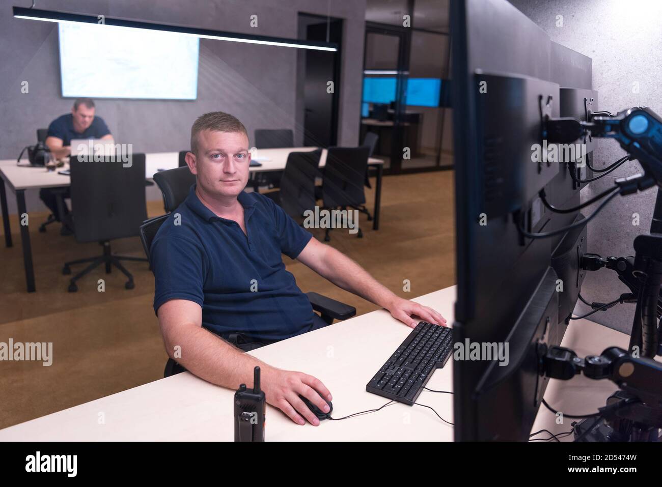 Male computer operator monitoring from a security ( computer, logistic ...
