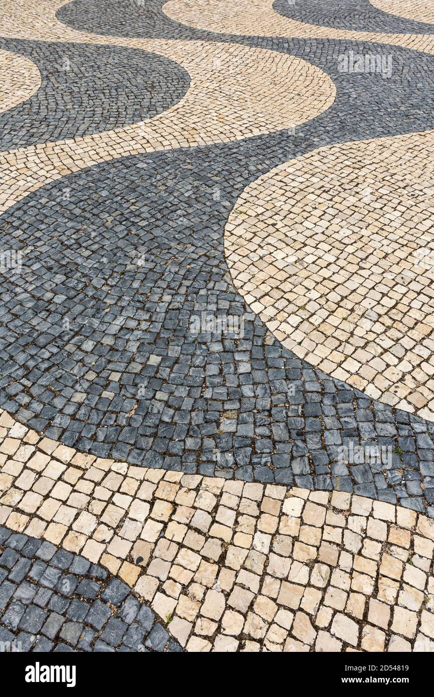 Beautiful view to wavy pattern made of portuguese stones on public square in central Lisbon, Portugal Stock Photo