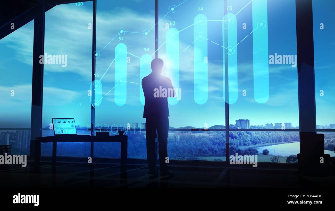 A businessman looks at a growth graph hologram at dusk Stock Photo - Alamy