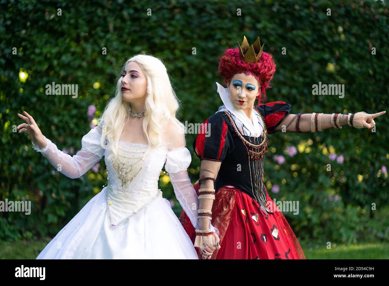 MUNICH, GERMANY - Sep 12, 2020: Cosplayer as characters from Alice in Wonderland. The red queen and white queen together Stock Photo