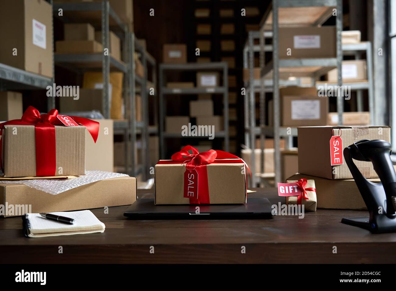 Table with gift parcel boxes on table in warehouse. Online ecommerce sale. Stock Photo