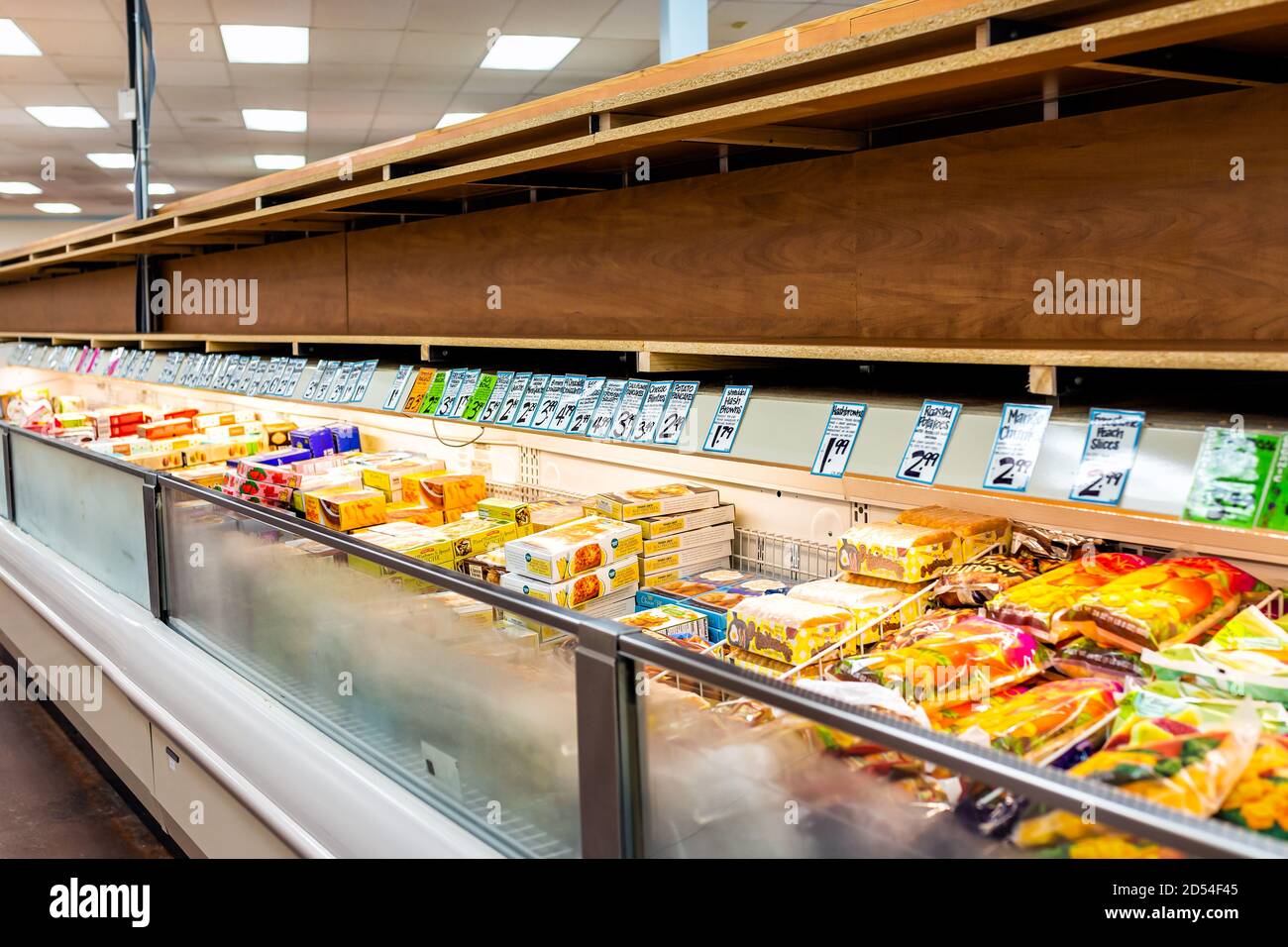 Reston, USA - July 9, 2020: Sold out empty shelf shelves at frozen aisle with price tags signs at Trader Joe's store during covid-19 Stock Photo