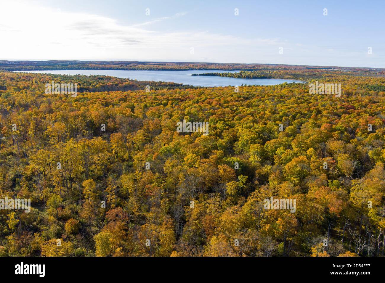 Autumn color from trees with a lake in the background in Door County Wisconsin from a drone Stock Photo