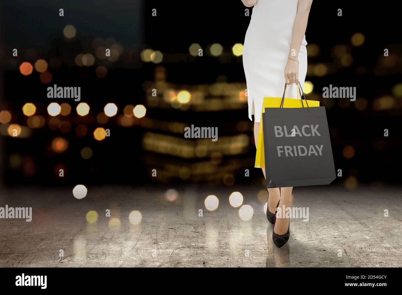 Women carrying a shopping bag with a blurred light background. Black