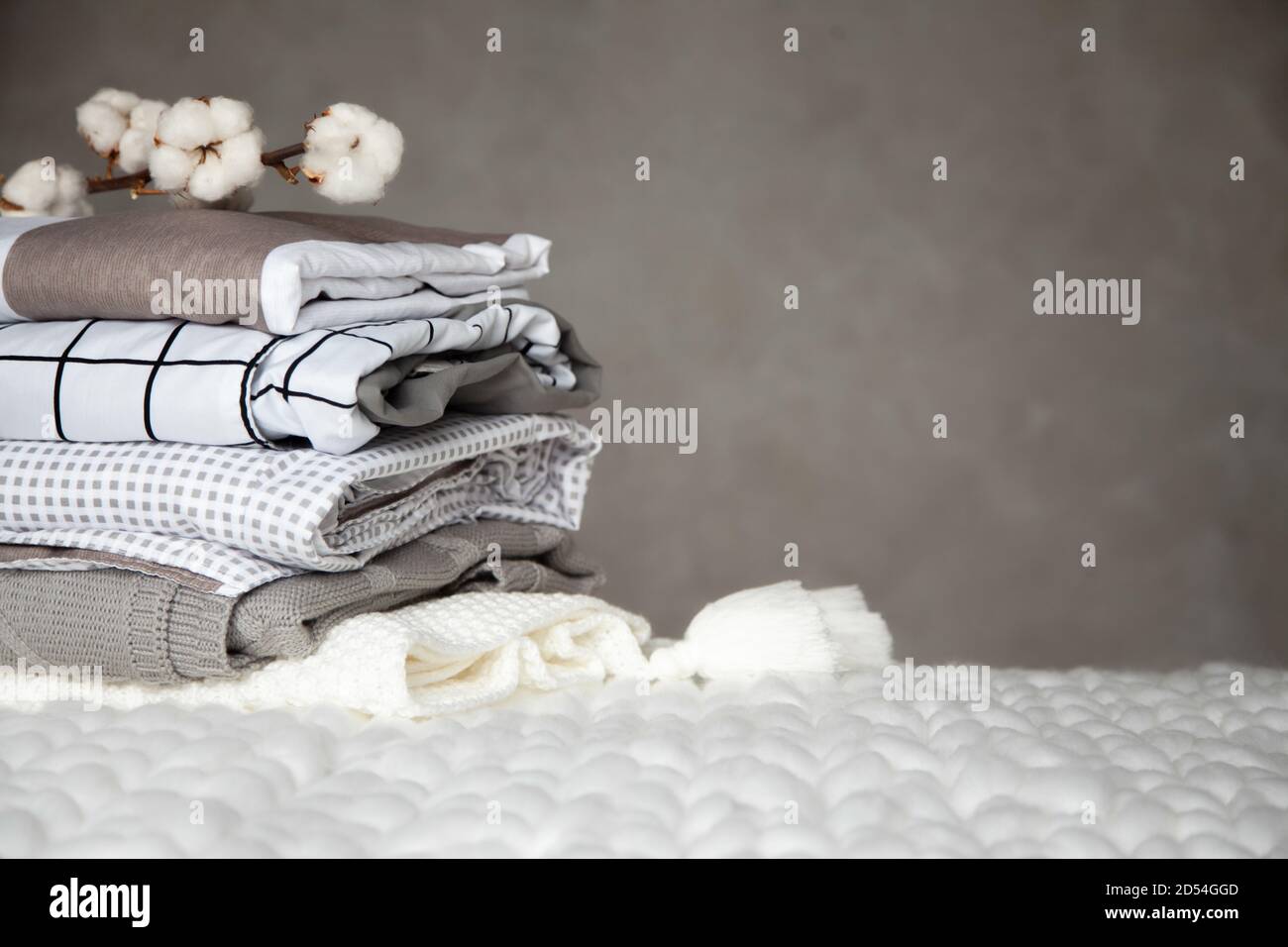 Stack of folded warm blankets with different design patterns and cotton