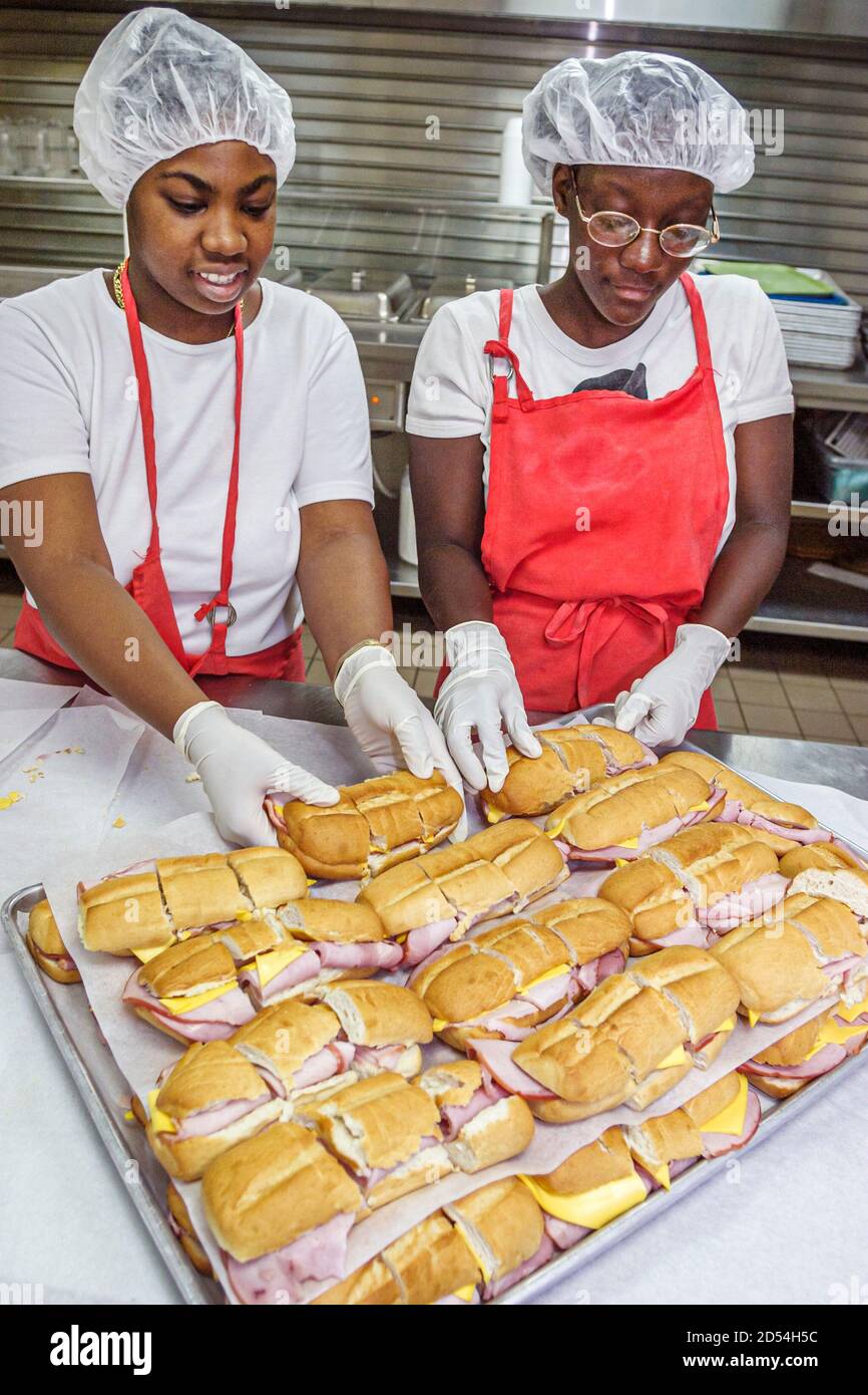 Miami Florida,Easter Seals Intergenerational Day,kitchen volunteer volunteers prepare preparing lunch food meals,Black African teen teens teenager tee Stock Photo