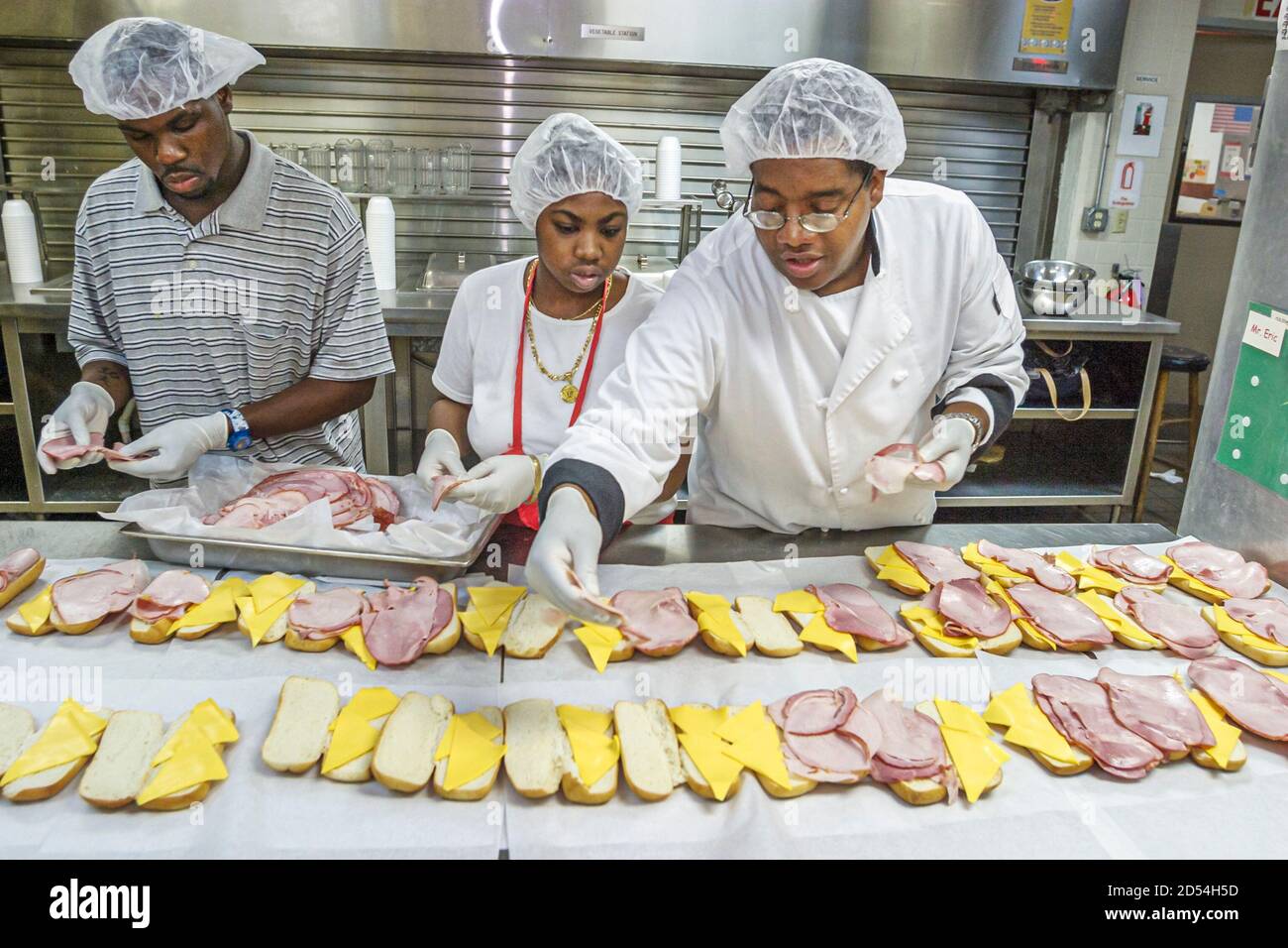 Miami Florida,Easter Seals Intergenerational Day,kitchen staff prepares preparing lunch food meals,Black African woman female women man male,wear wear Stock Photo