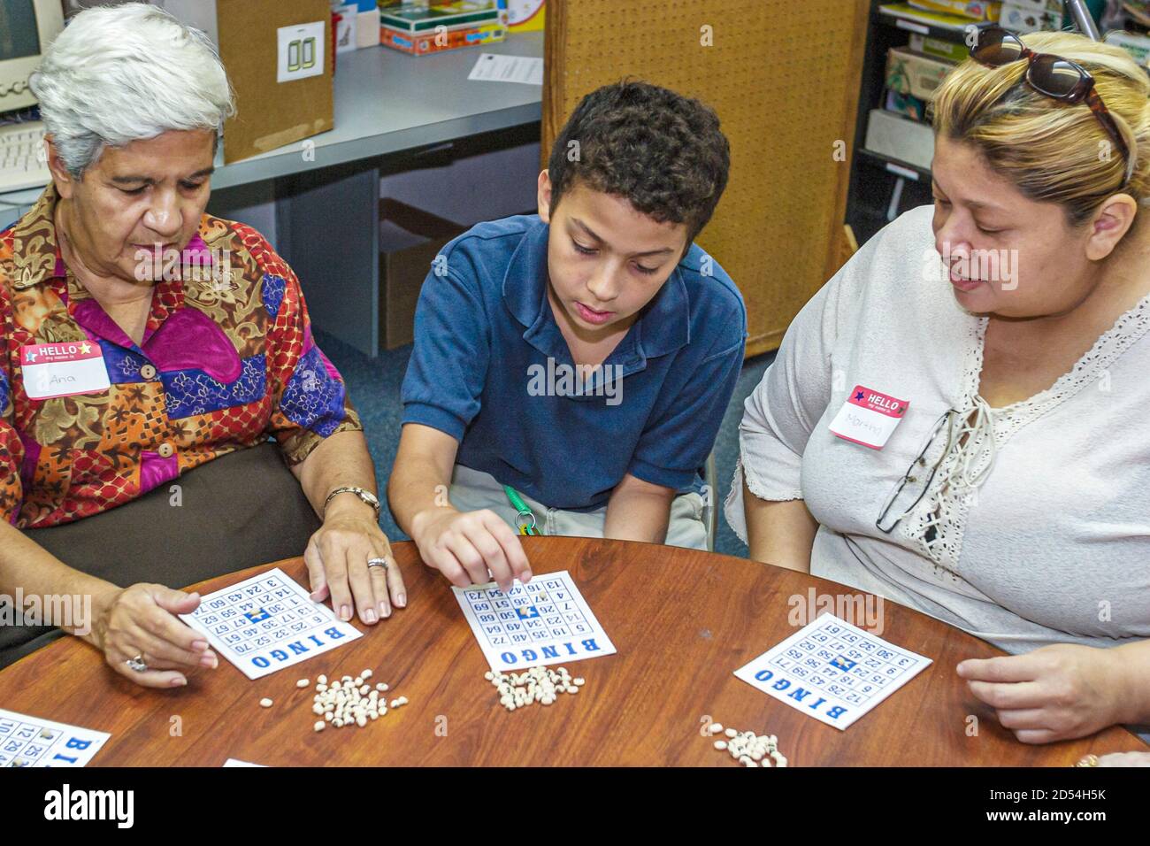 Miami Florida,Easter Seals Intergenerational Day,senior seniors woman female women Hispanic,boy volunteer visits visiting plays play playing bingo, Stock Photo