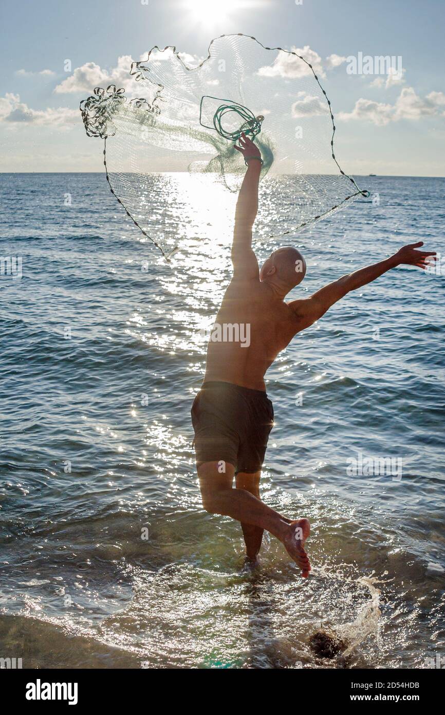Miami Beach Florida,Atlantic Ocean surf,casting tossing fishing net,water man male silhouette silhouetted, Stock Photo