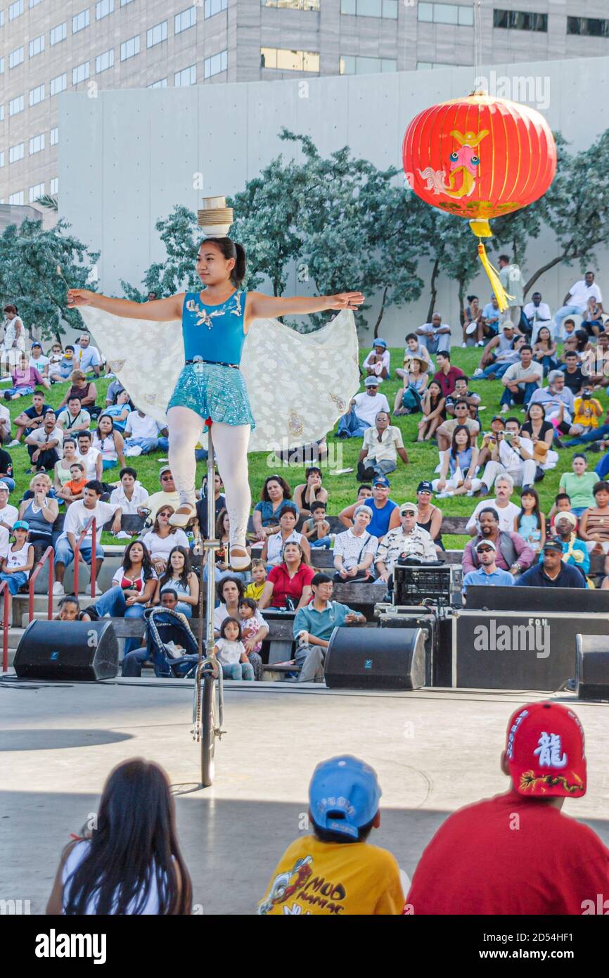 Miami Florida,Bayfront Park Hong Kong Dragon Boat Race Festival,Asians girl female acrobat acrobatic act,riding unicycle balancing performing stage au Stock Photo